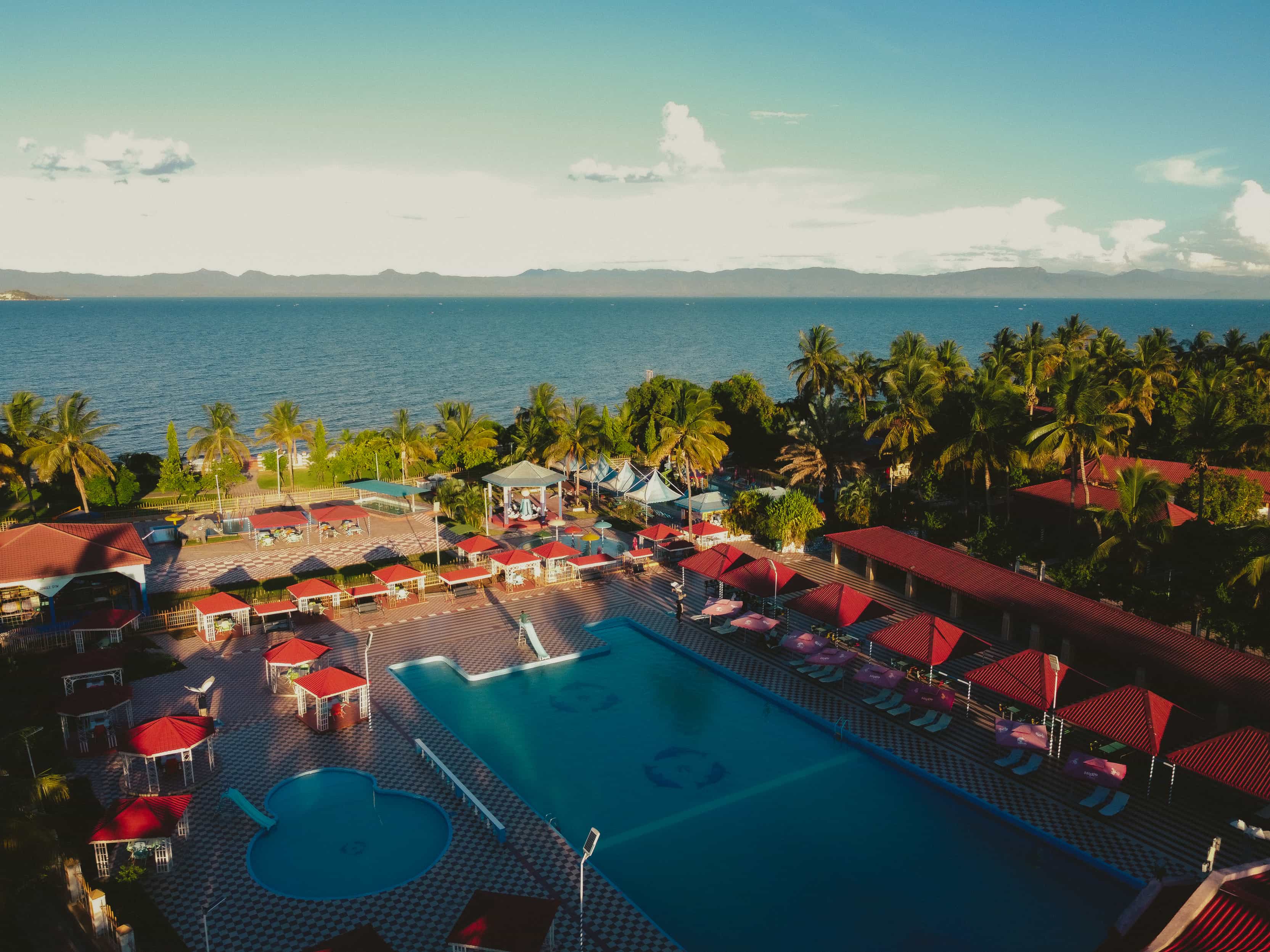 aerial view of swimming pools and lake
