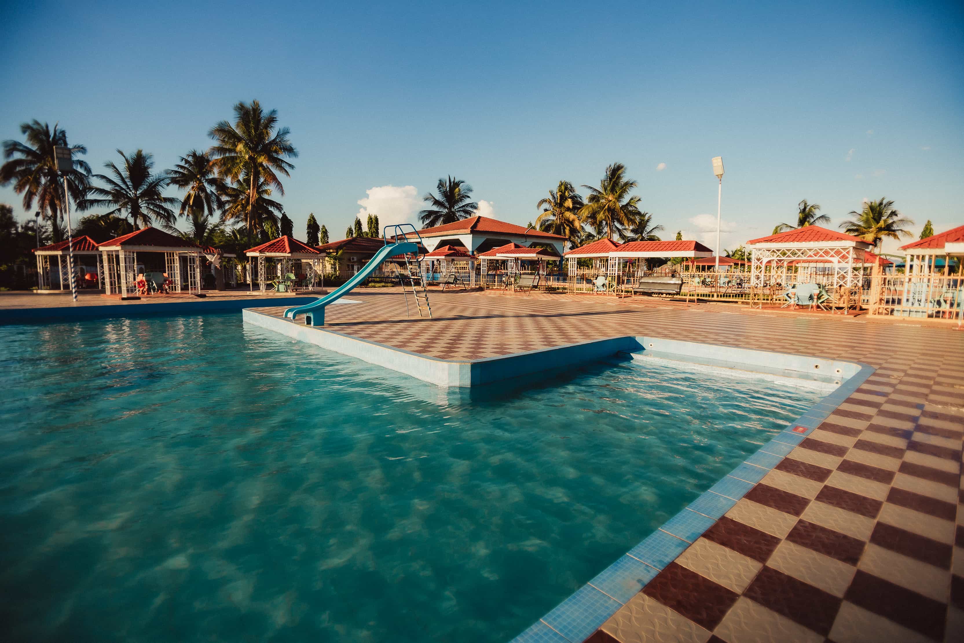 view of pool with slide and seating area