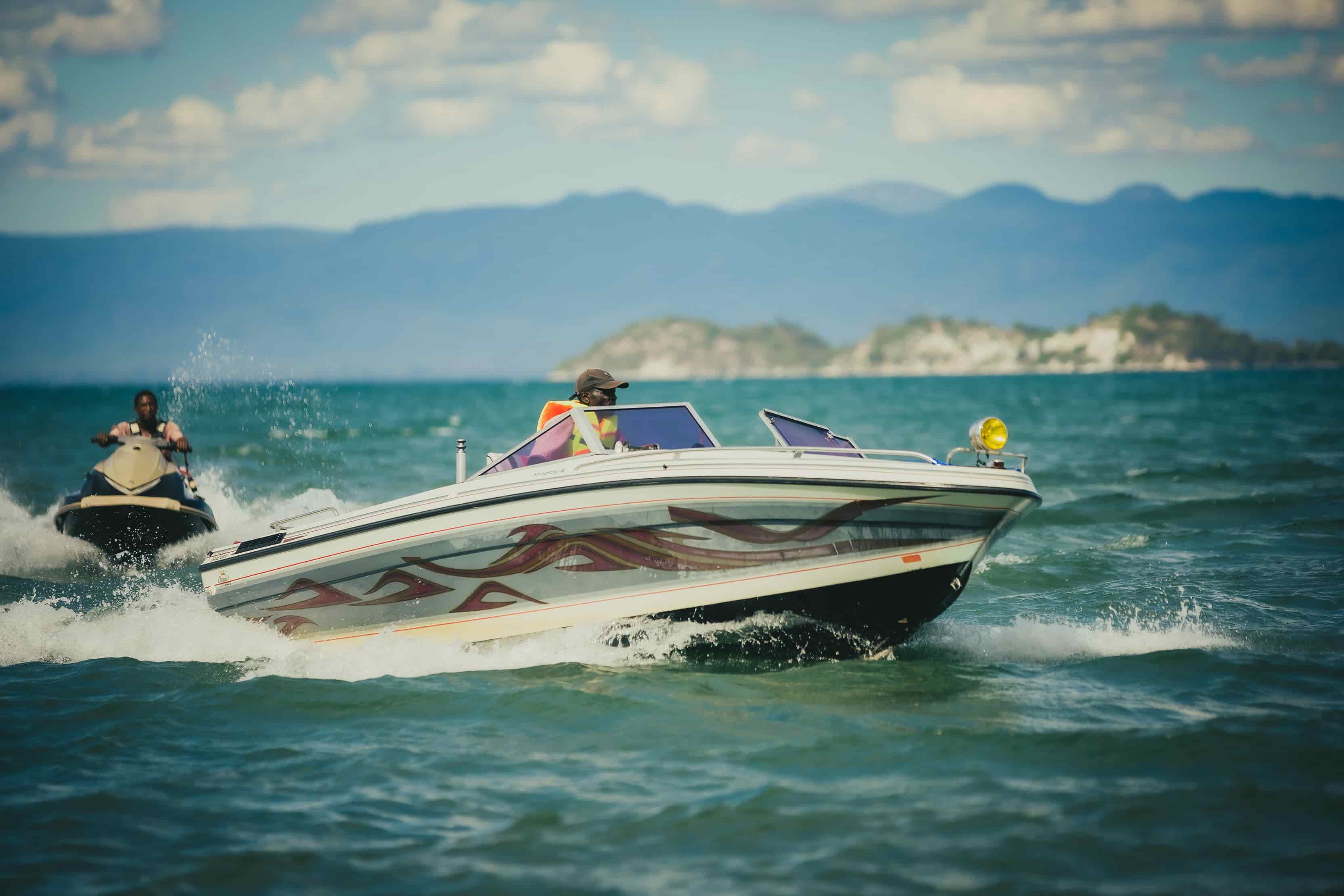 boat cruising on the lake with jetski behind it