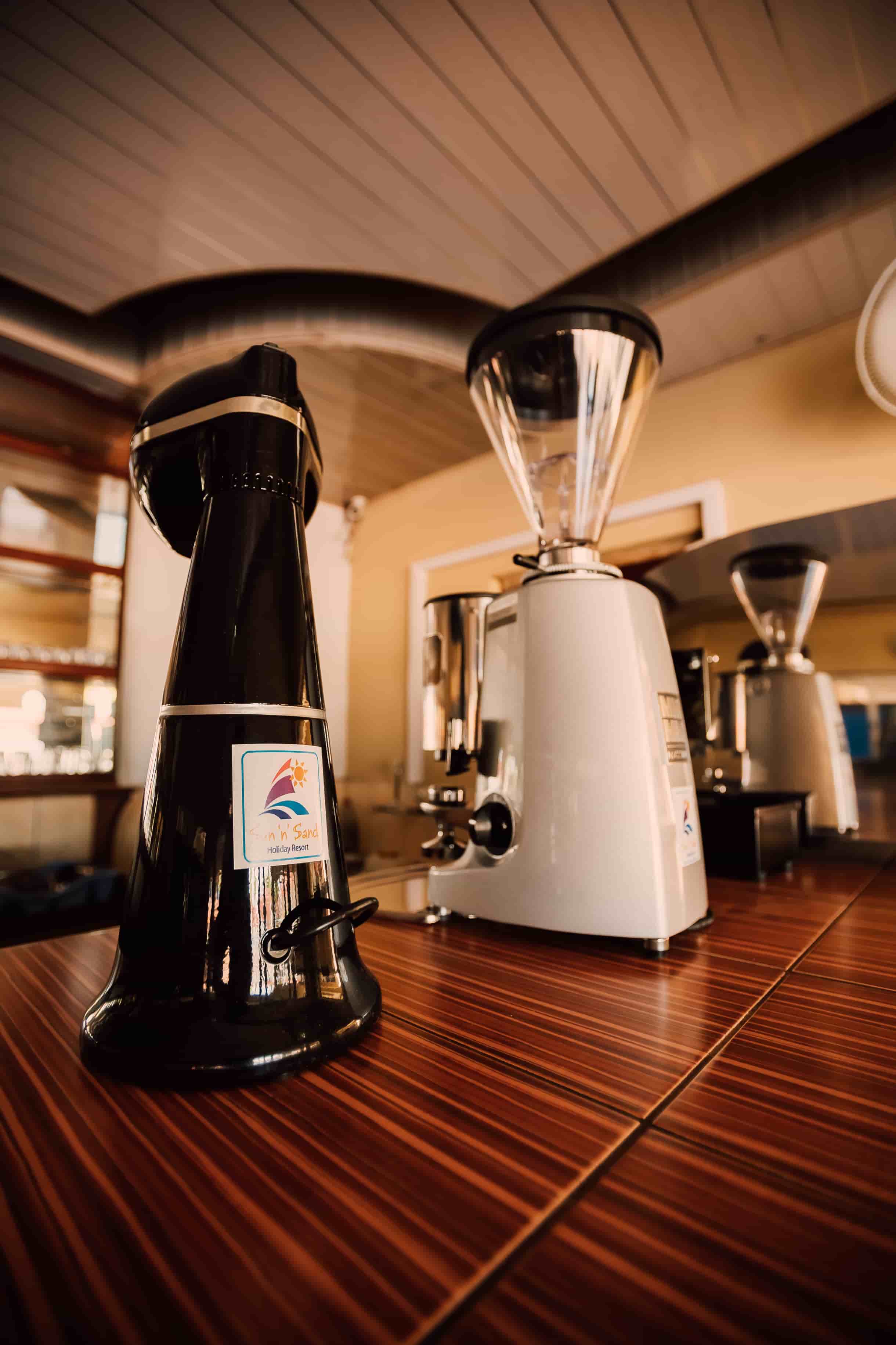 2 coffee machines ontop of coffee shop counter