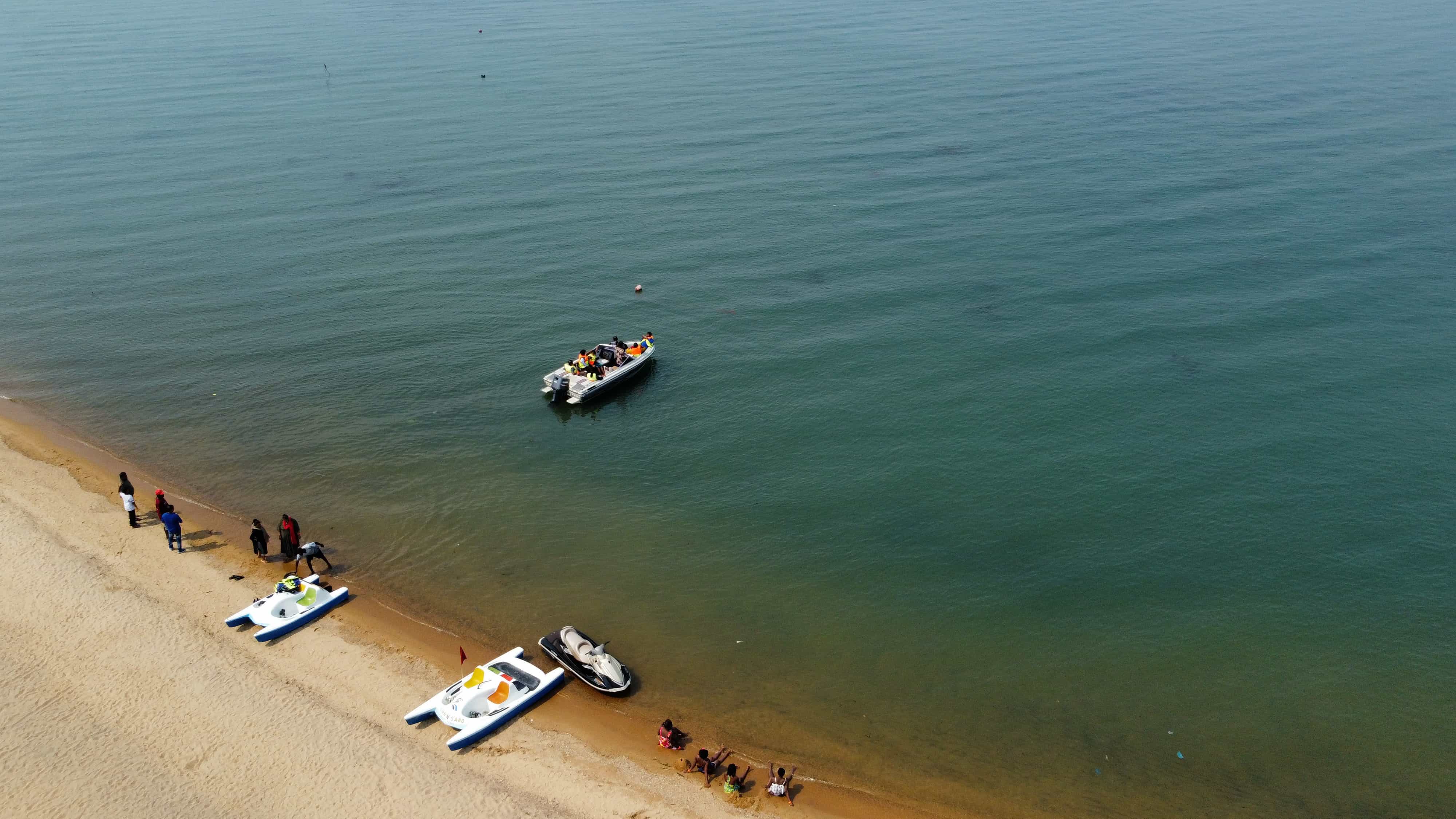 Aerial view of paddle boats jetski and boat on the lake