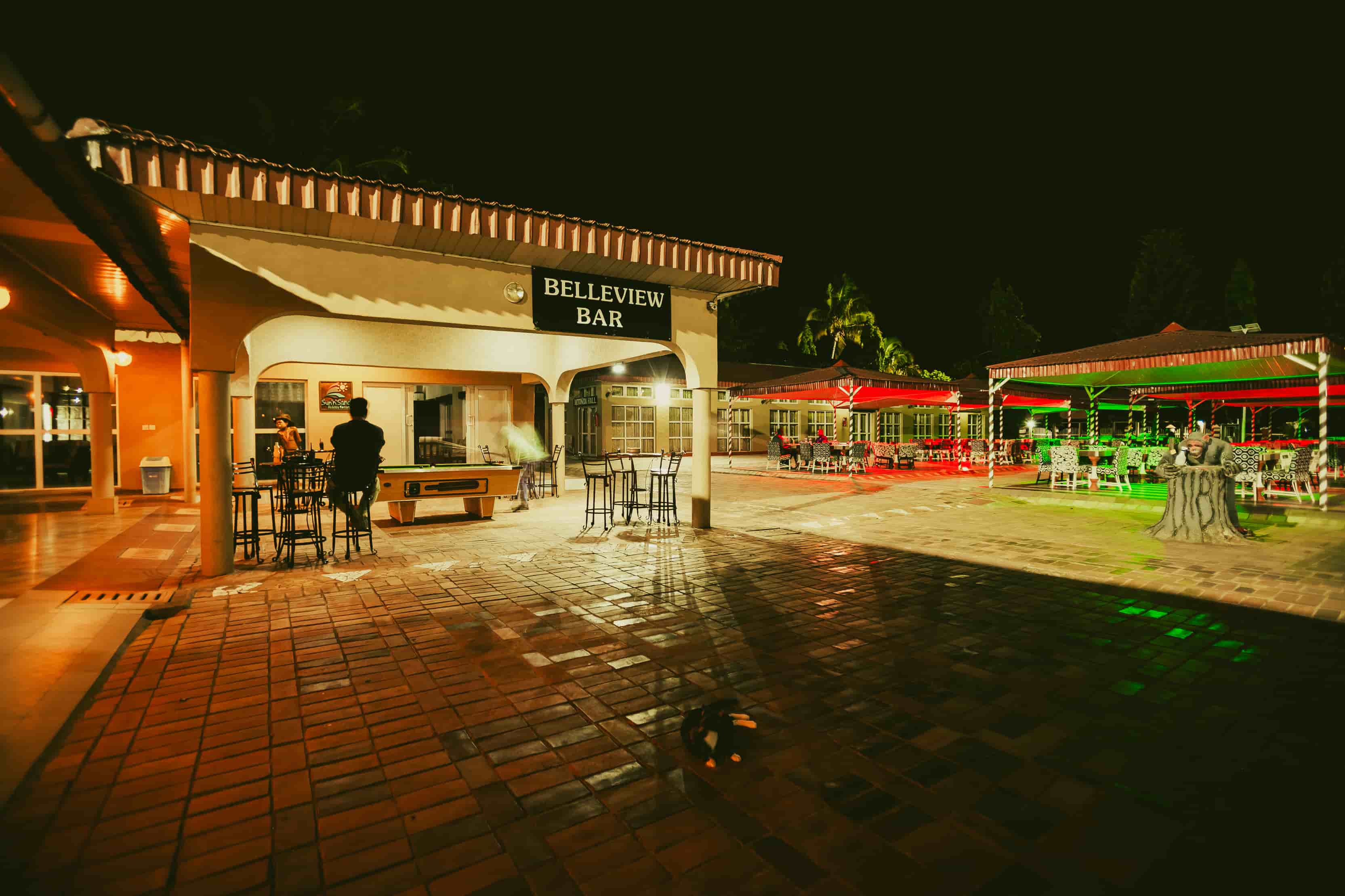outside view of bar at night with sign