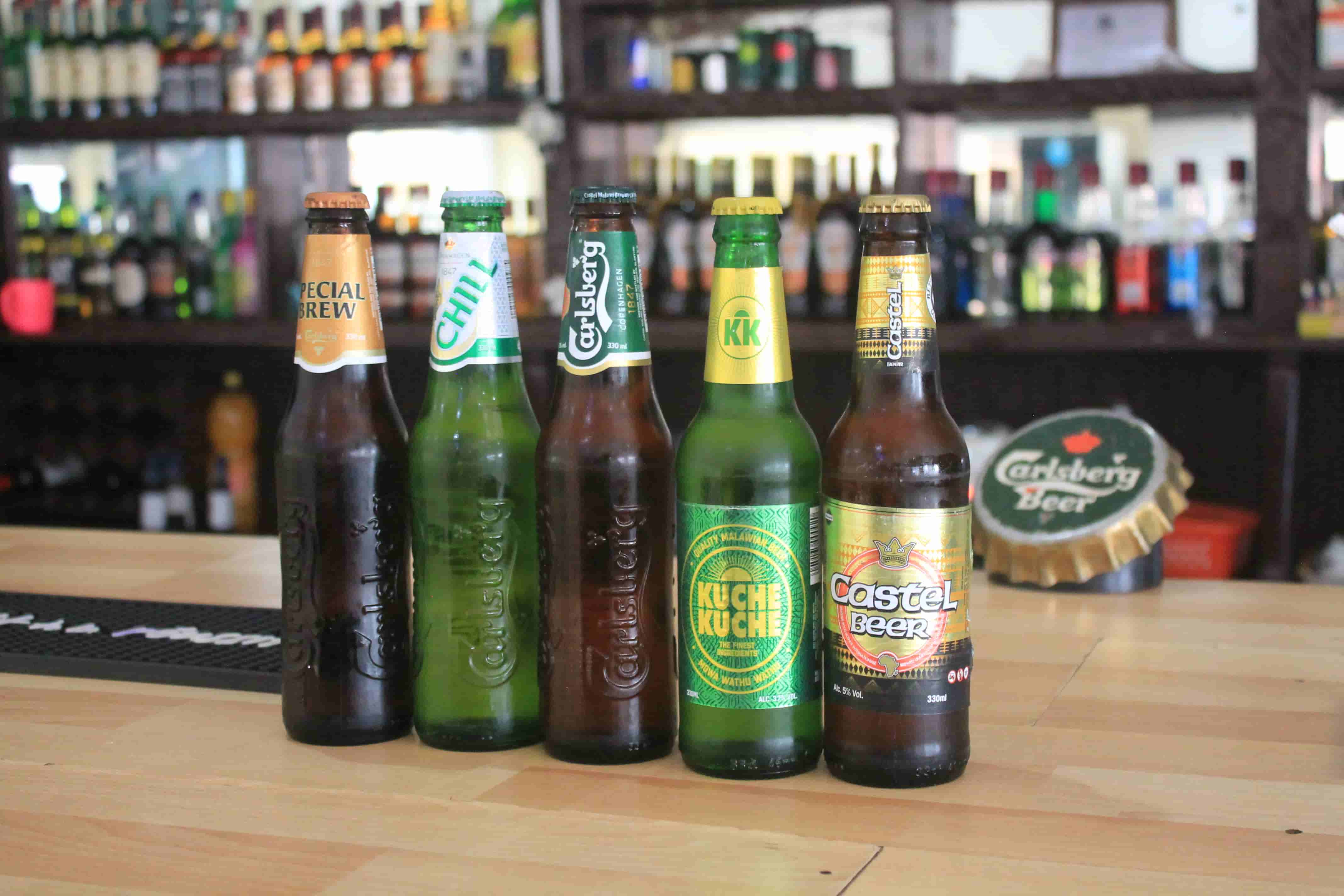 close up of different beers on bar table