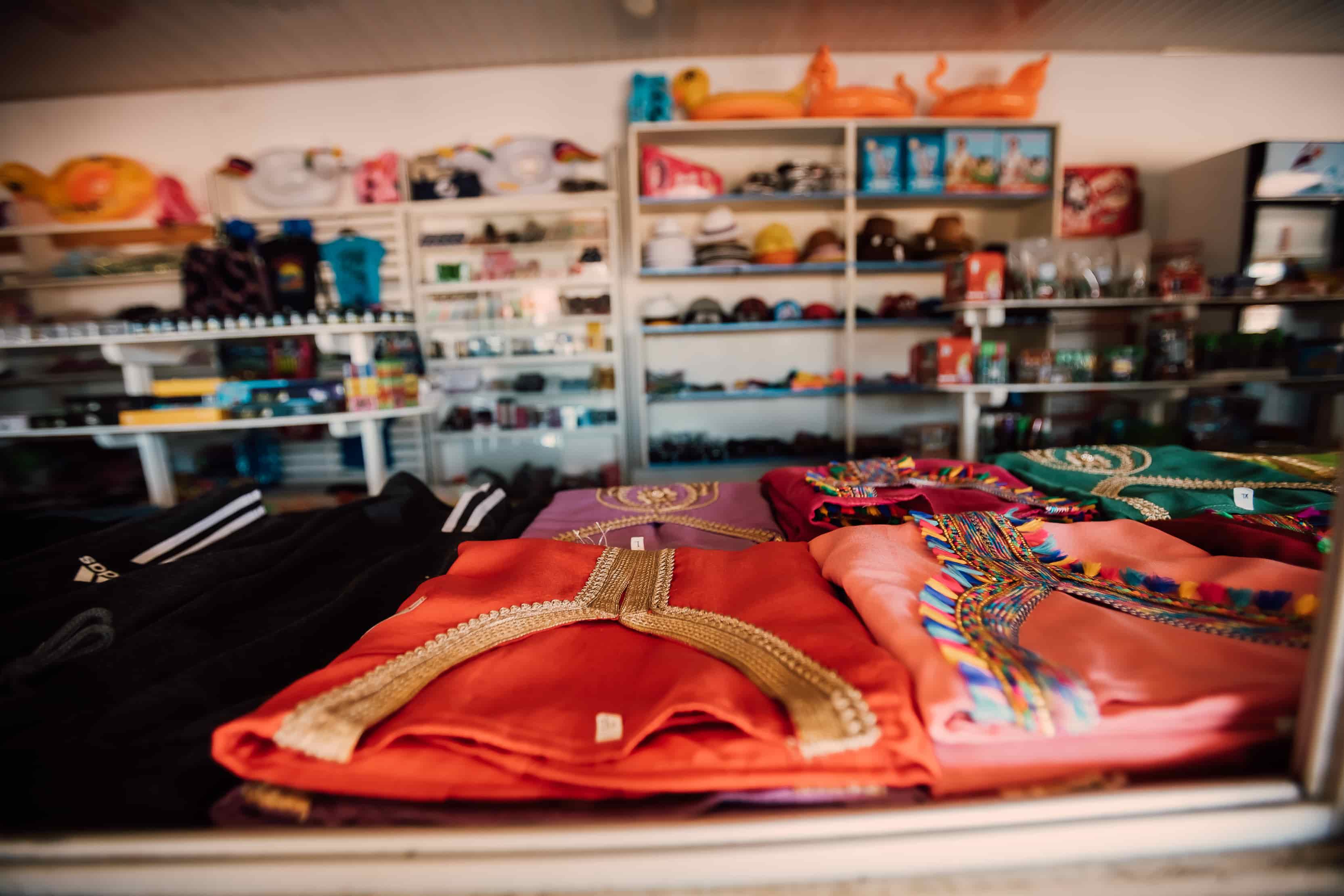 Colorful tops on shop counter close up