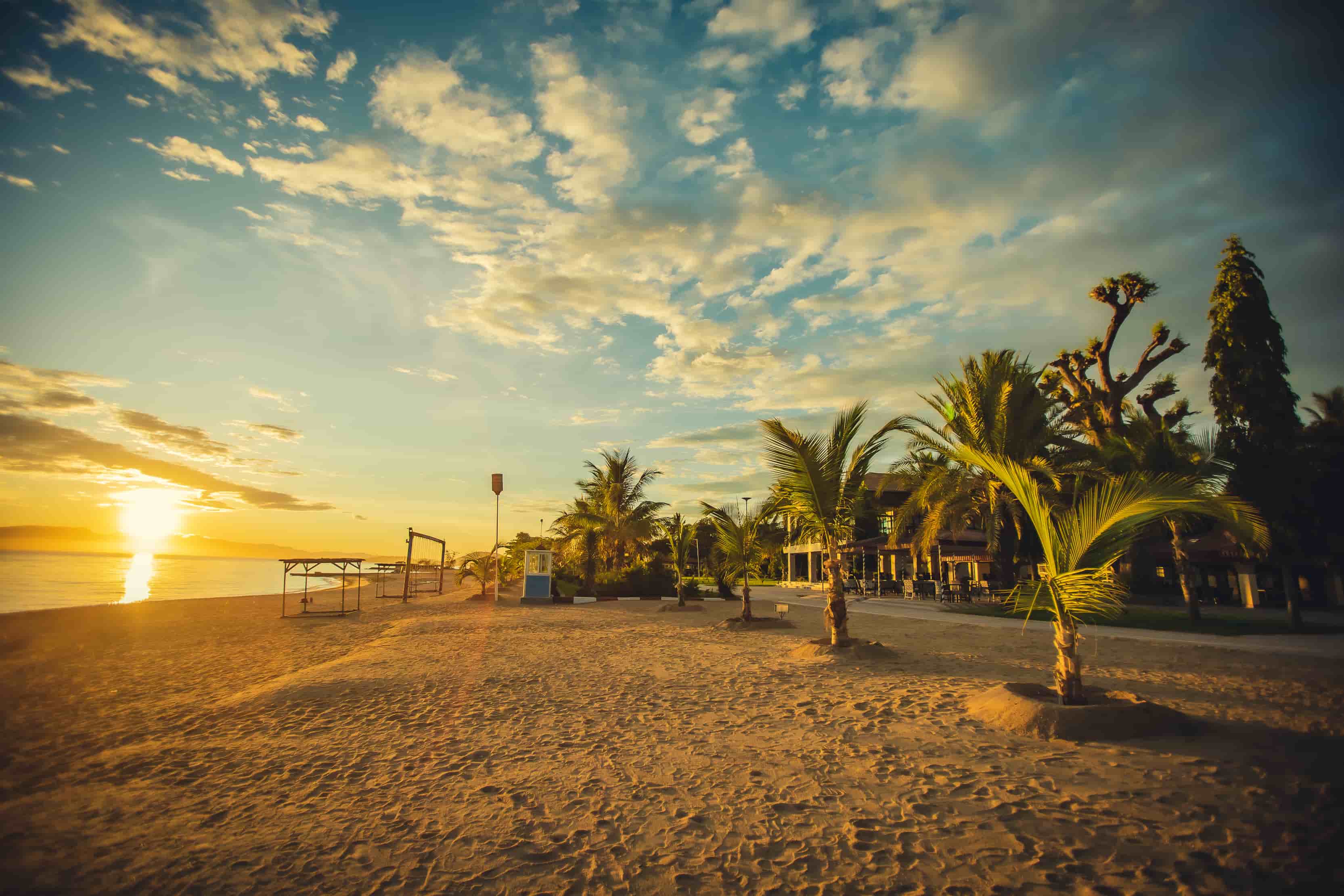 Golden evening light across the resort’s palm-lined lakeshore